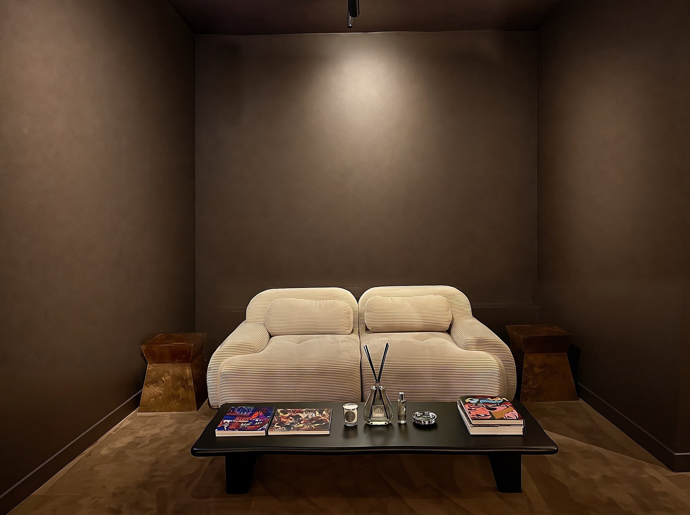 The lower lounge with its cream corduroy sofa and artworks, without artworks