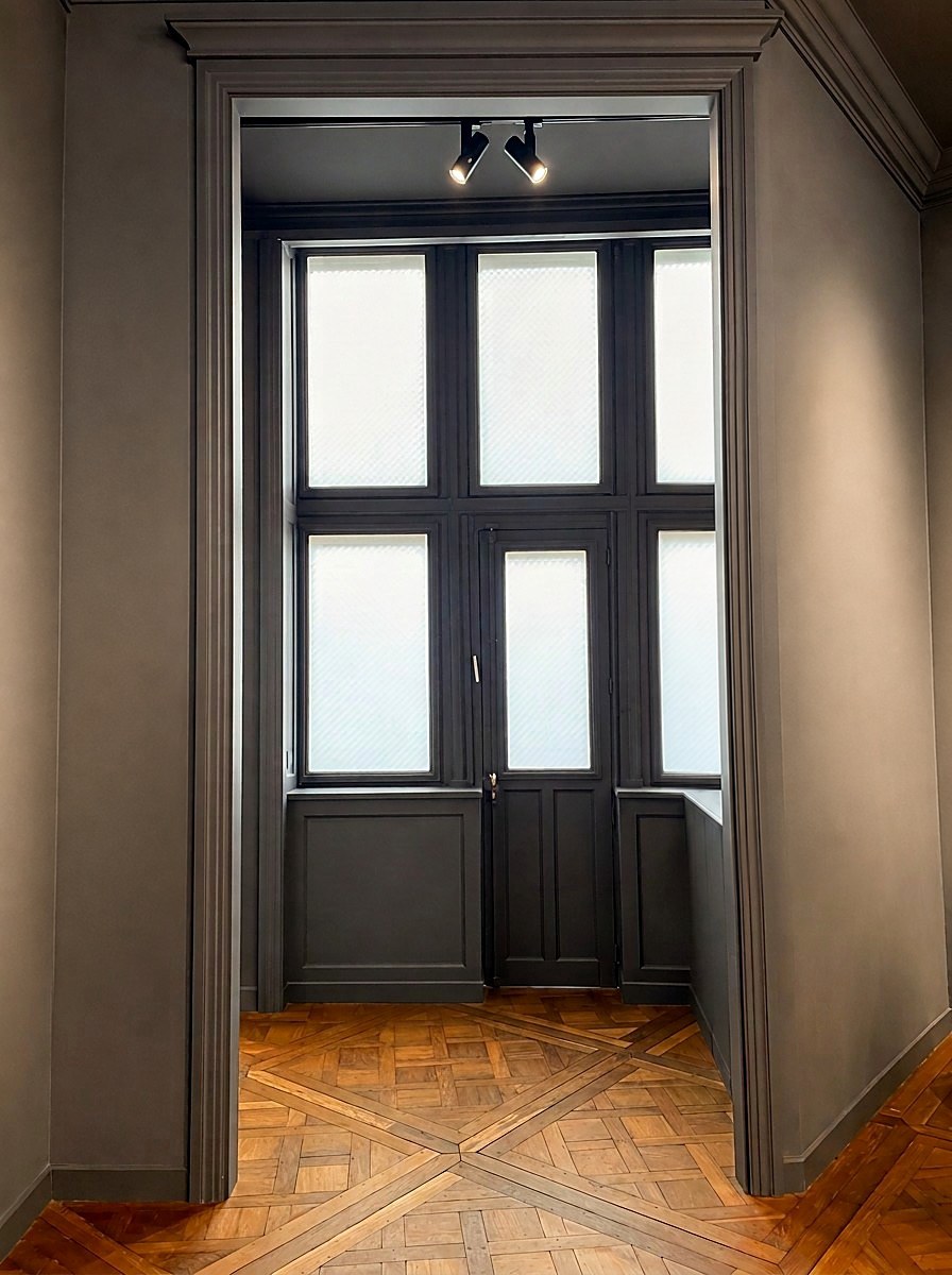 The back room with its glazed window and parquet de Versailles, without artworks
